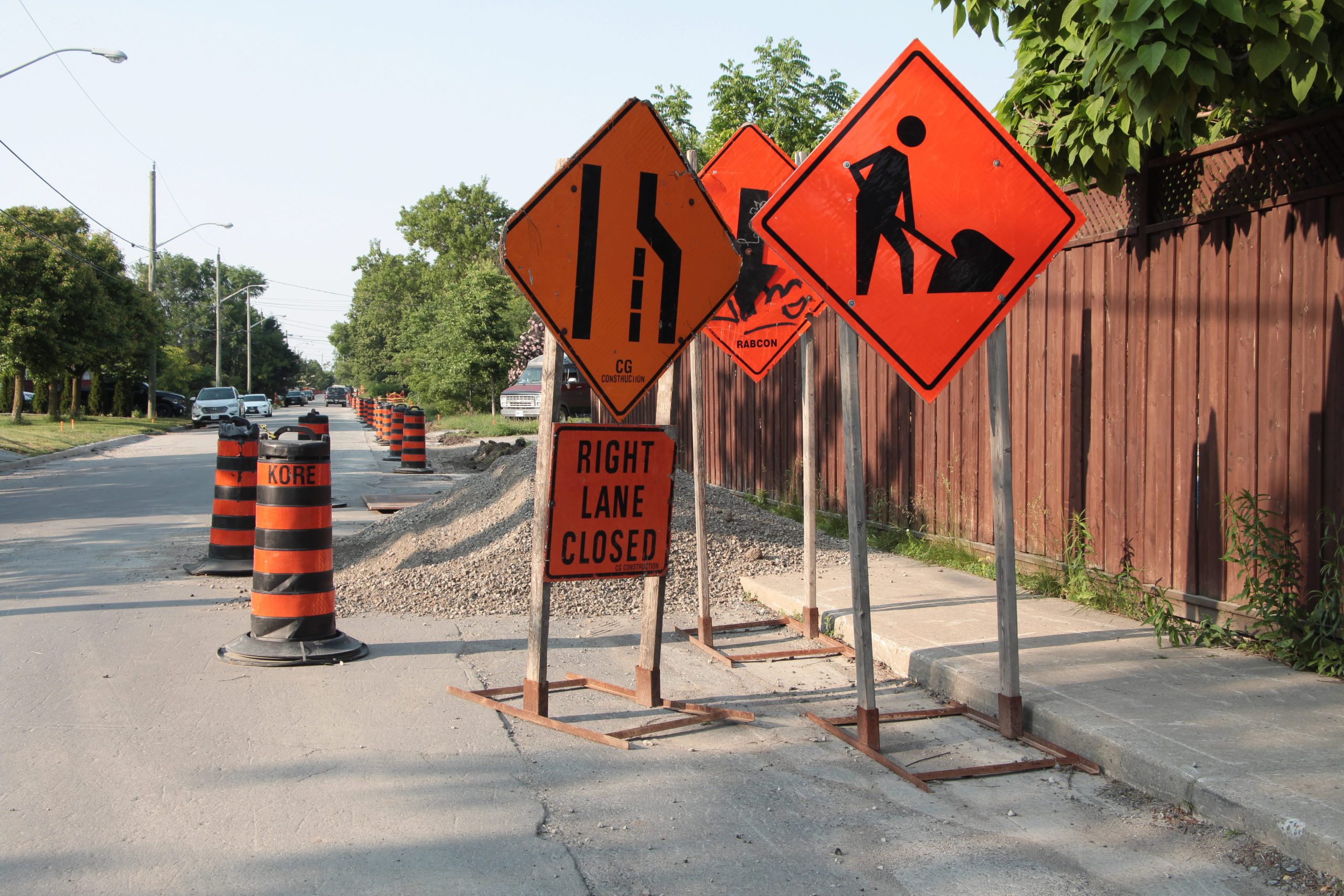 Traffic signs indicating road work, lane closures, and construction hazards.