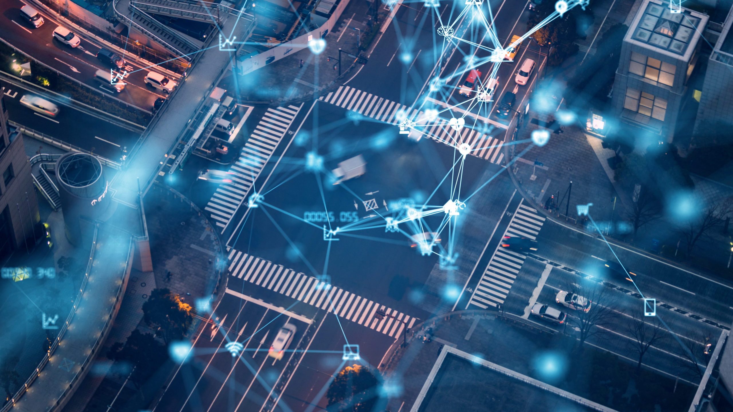 Aerial view of a city intersection with digital network graphics overlay, illustrating urban connectivity and smart technology integration in transportation.